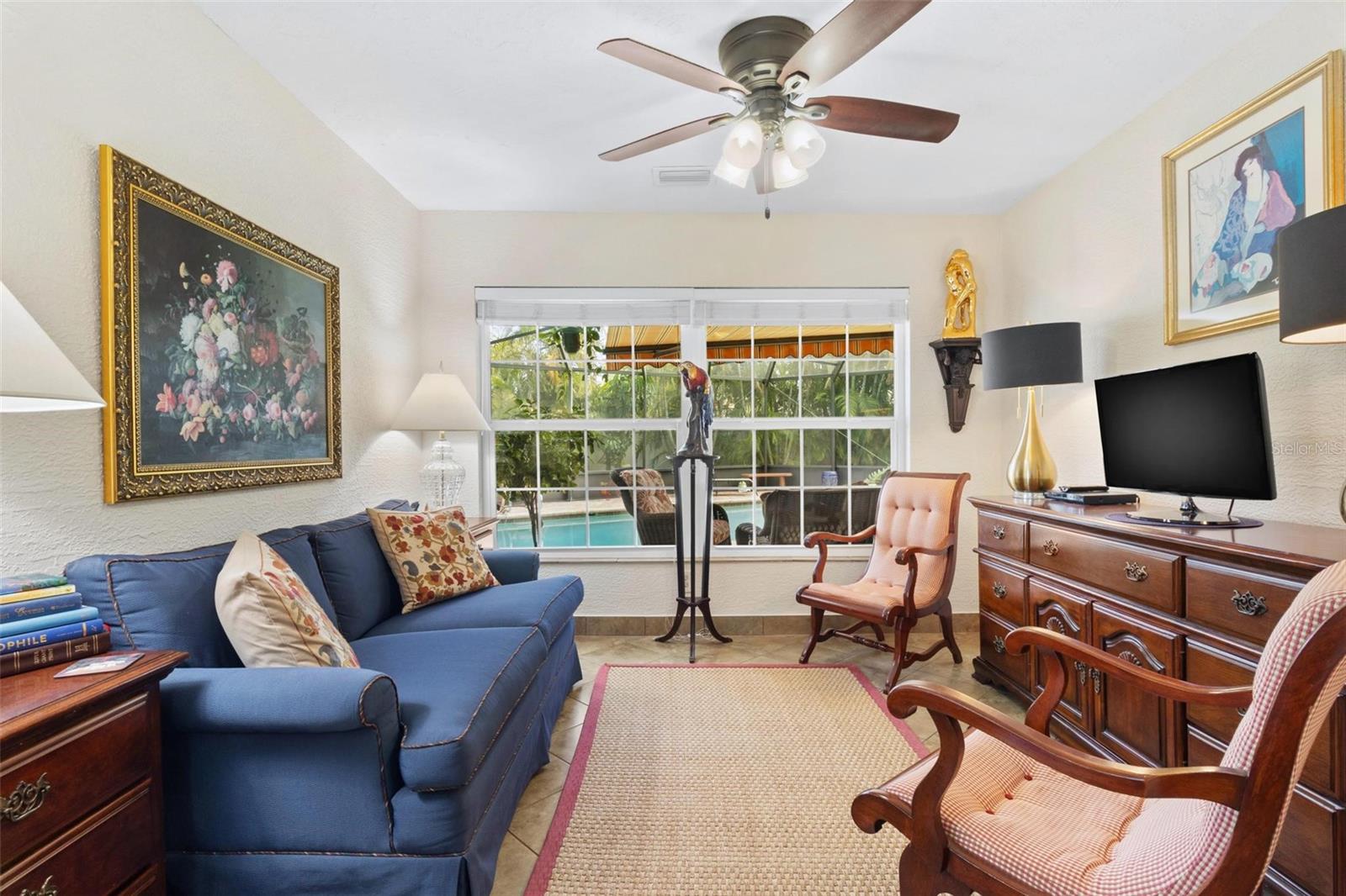 It includes a cozy sitting area overlooking the pool.