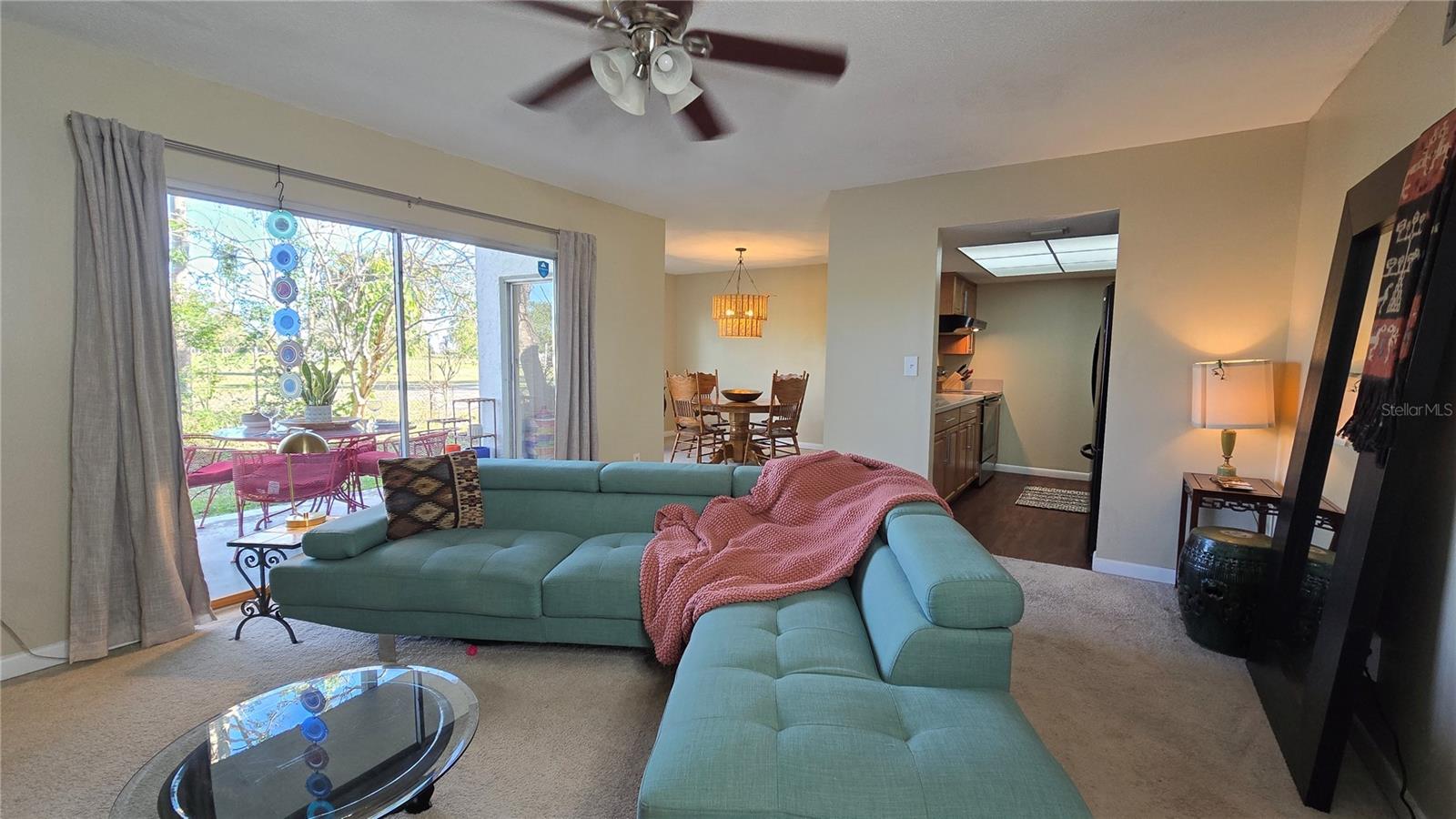 Another view of the living room with a view of the beautifully appointed kitchen and dining room