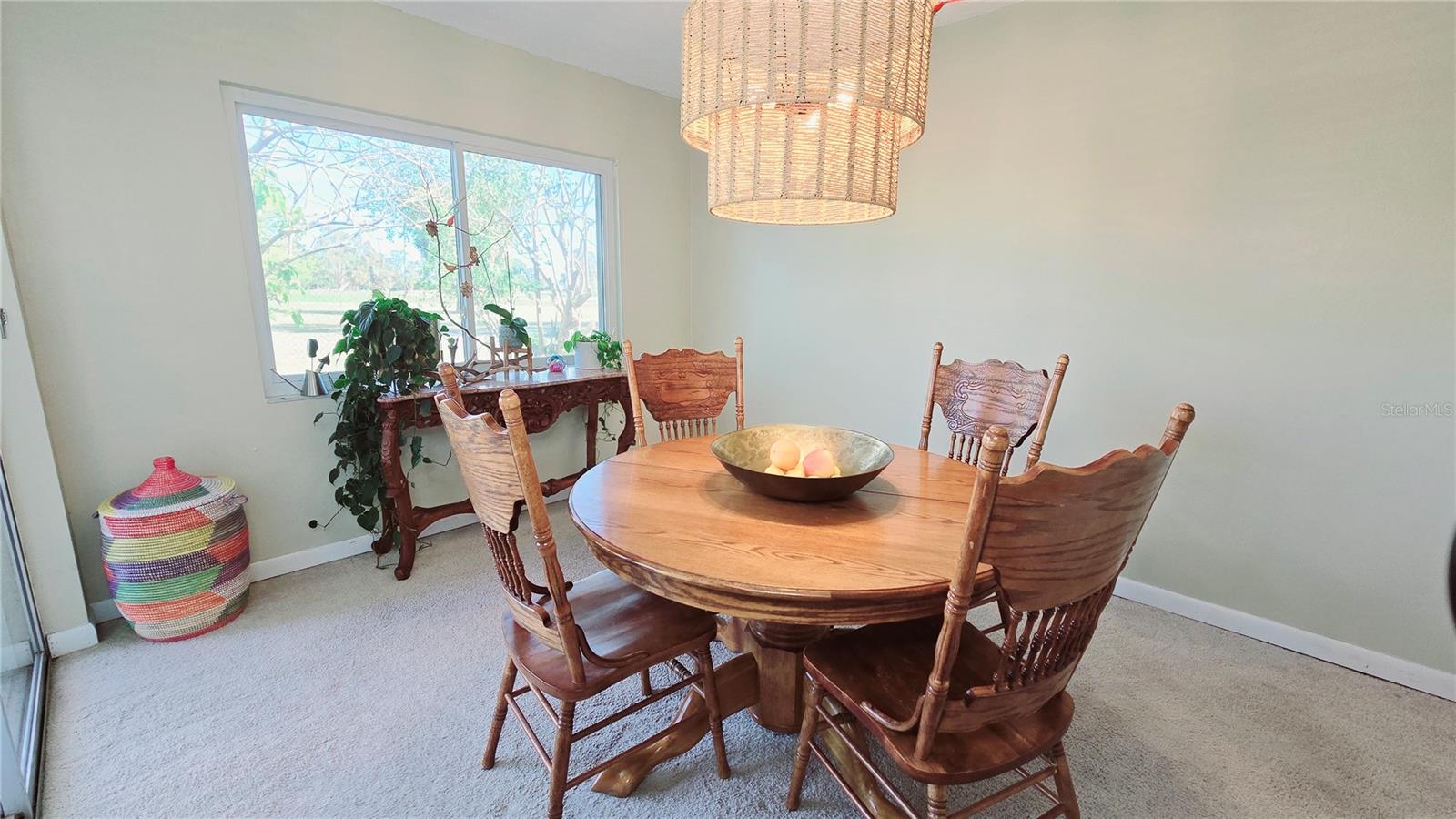 Large Dining Room with picturesque window and sliding glass door to the private patio.