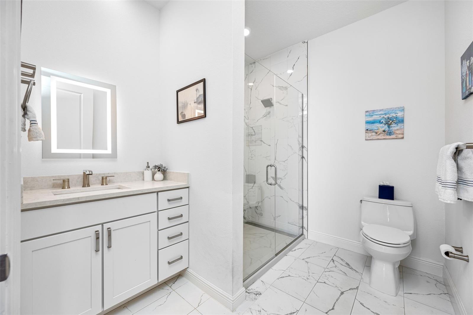 3rd Bathroom features a single vanity with quartz countertop, vanity light-up mirror, and walk-in shower