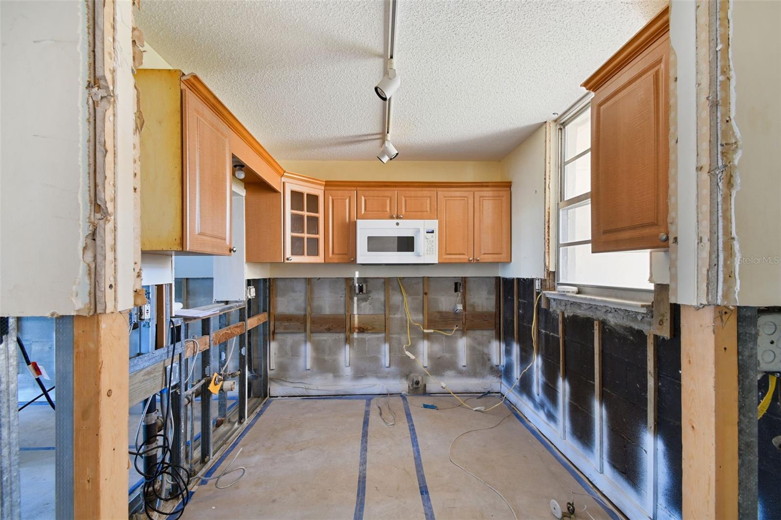 Picture all new white shaker style cabinetry, white quartz countertops, white tile backsplash, brand new GE stainless steel appliances including refrigerator, dishwasher and range.