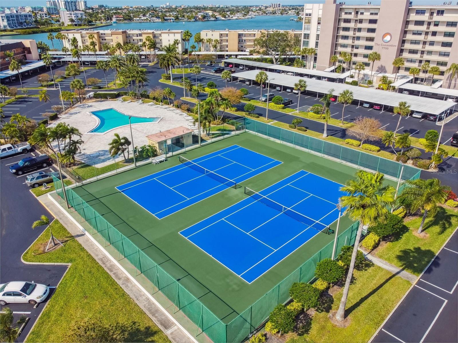 Main Center Pool (1 of 6) and 2 of the 4 tennis courts. Enjoy the huge pool deck, with sun loungers, tables and chairs and gas grills.