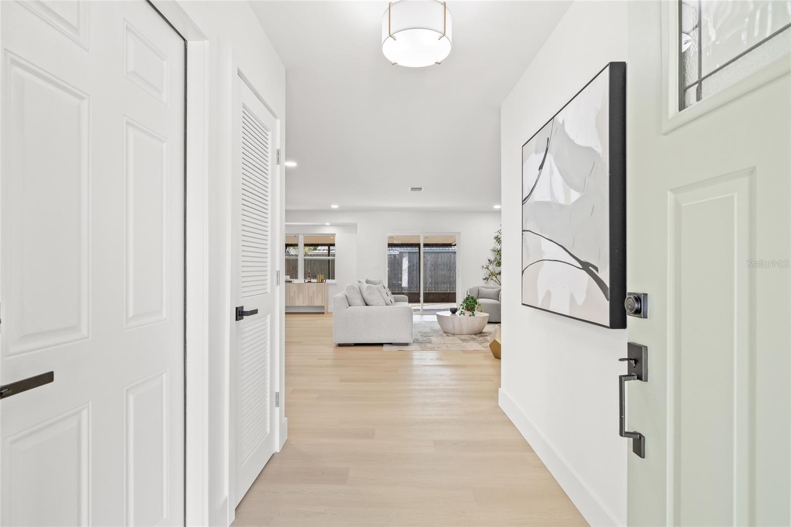 Entrance leads to Open Floor Plan. Door to the left leads to 2 Car Garage.