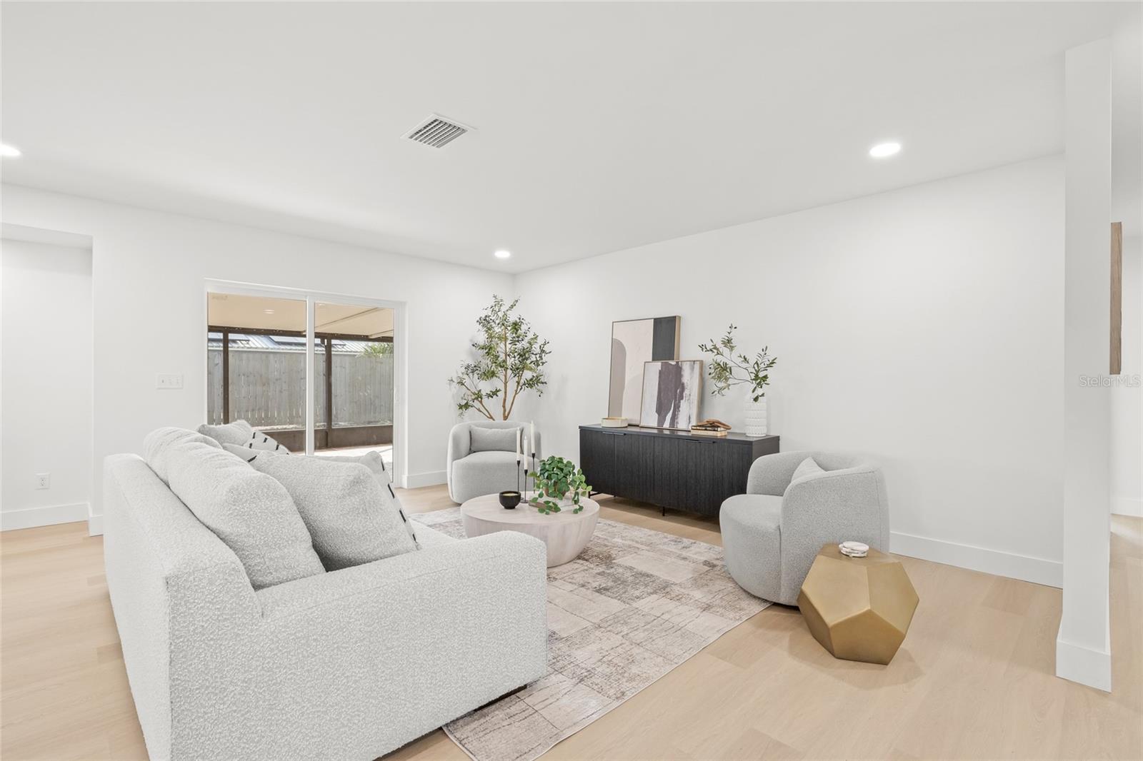 Living Room- New sliding doors lead to large covered screened porch.