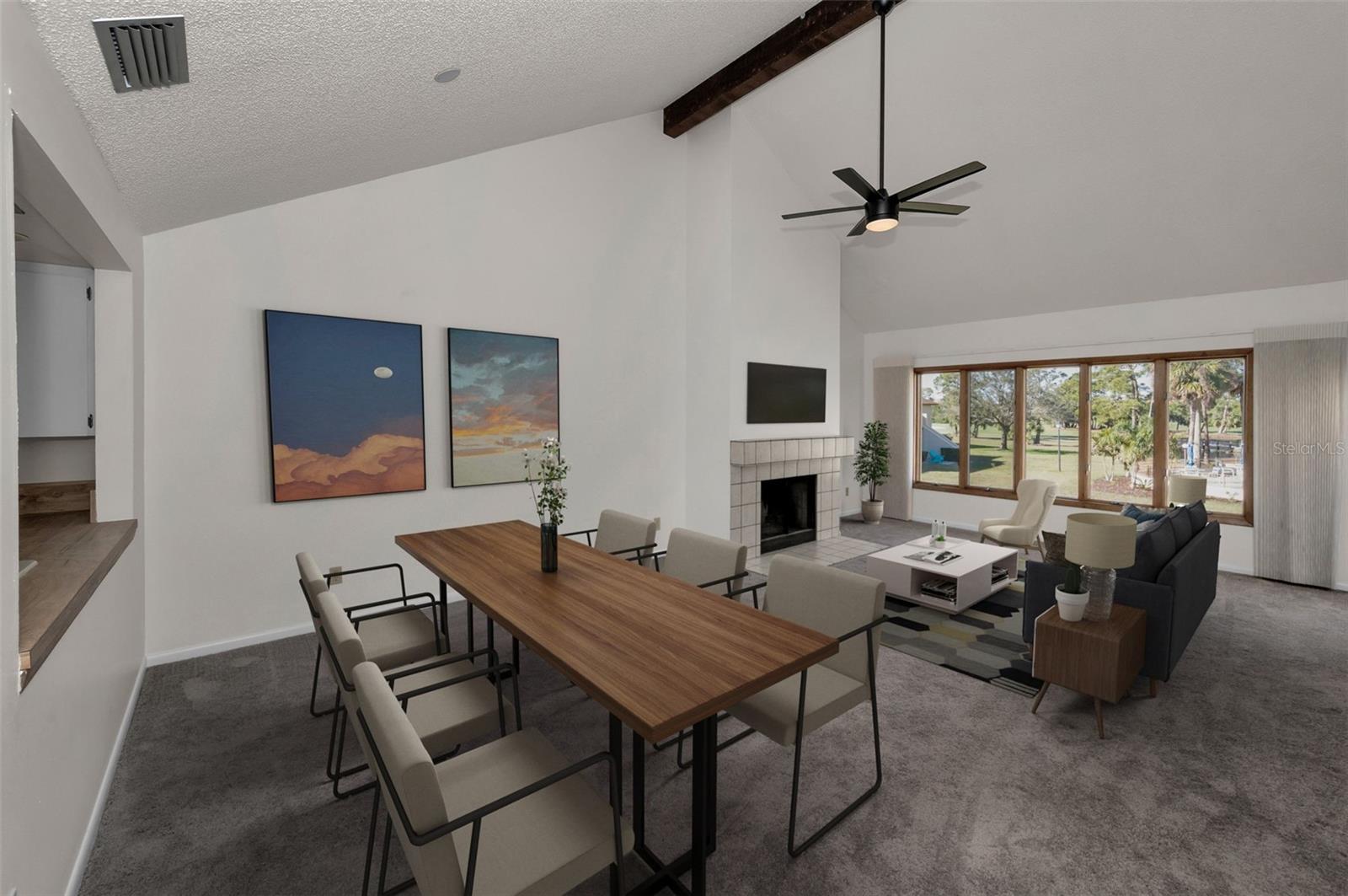 Living and dining with a view always!!  The lovely vaulted ceiling with the beam and the fireplace!