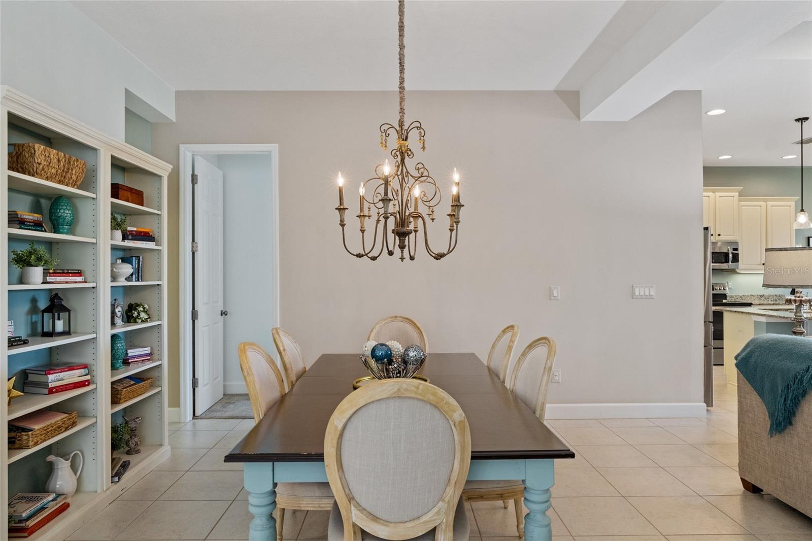 Beautiful chandelier adorns the large dining area with bedroom 2 straight ahead