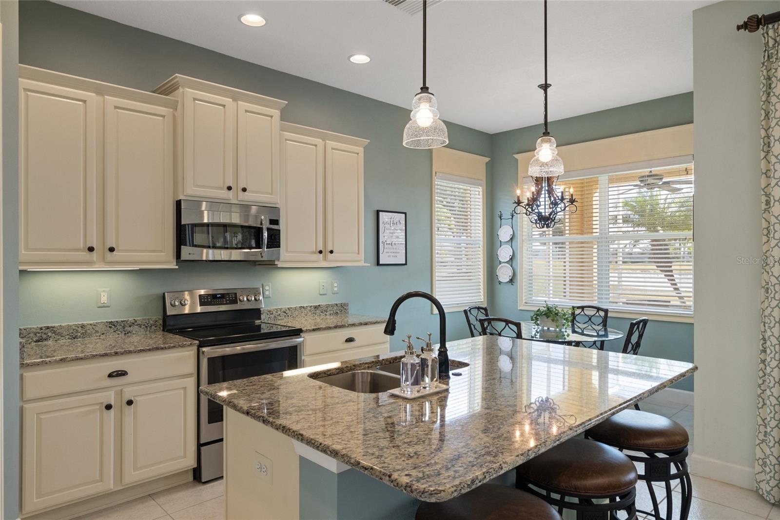 Kitchen has stainless appliances, granite countertops, dual sink, recessed lighting and great natural light coming in by the eat-in breakfast nook