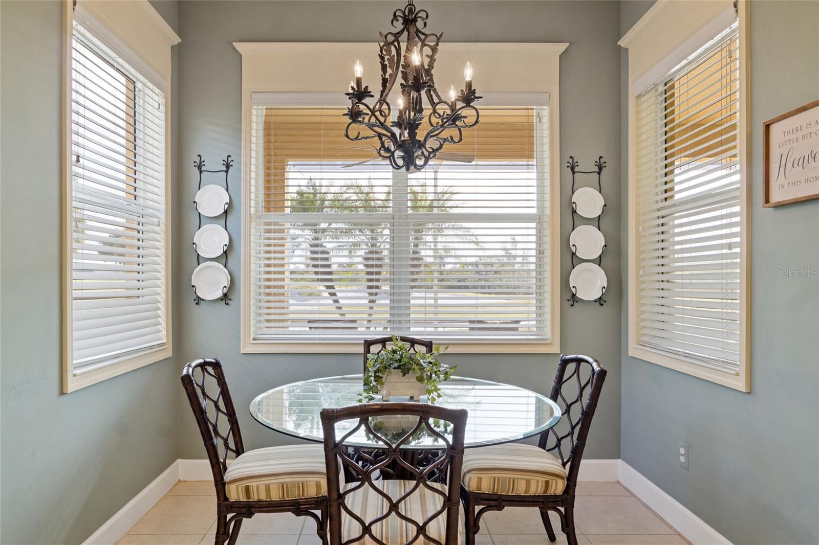 Eat-in breakfast nook with large wood encased windows that bring in natural light as you overlook the 7th hole of the golf course