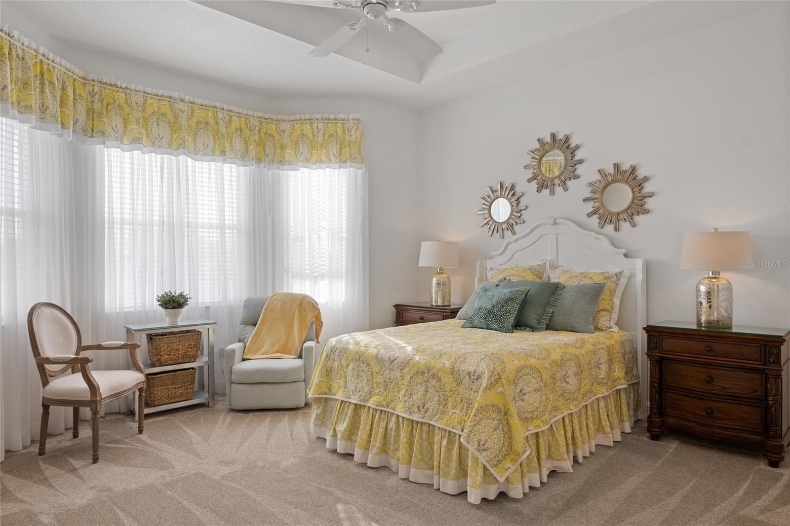 Master suite with tray ceilings & large bay windows bringing in natural light to the sitting area as you overlook the 7th hole of the golf course