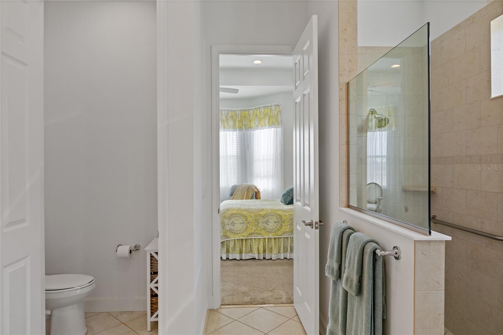 Ensuite with separate toilet closet & large walk-in shower with grab bars