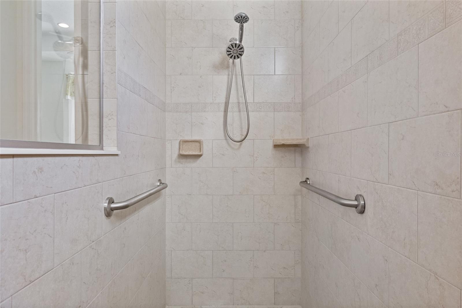 Tiled walk-in shower with grab bars