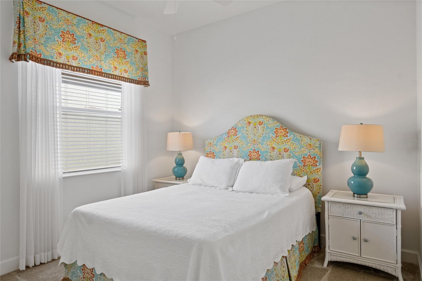 Freshly painted bedroom 2 with large window to bring in natural light, high ceilings and ceiling fan