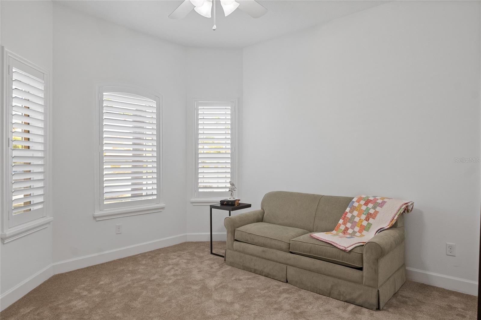 Freshly painted front bedroom 3 can be used for an office, craft room or guest room. Plantation shutters adorn the bay windows.