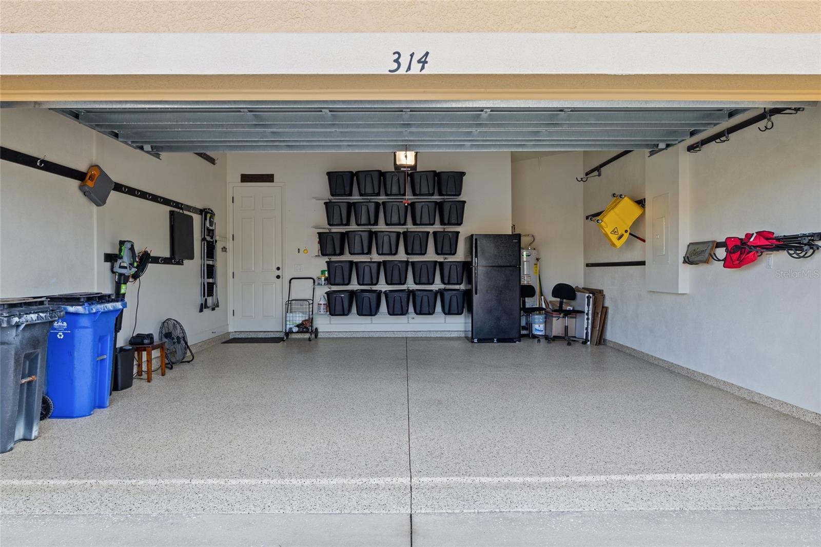 Epoxy floored garage with plenty of room for a vehicle, golf cart & extra toys for Florida living.