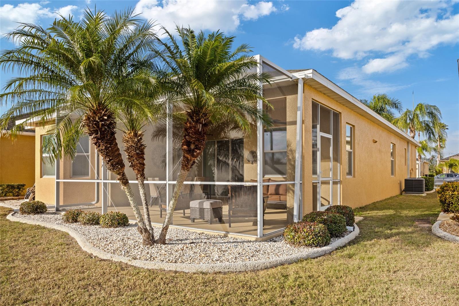 Clean and crisp landscaping adorn the screened lanai