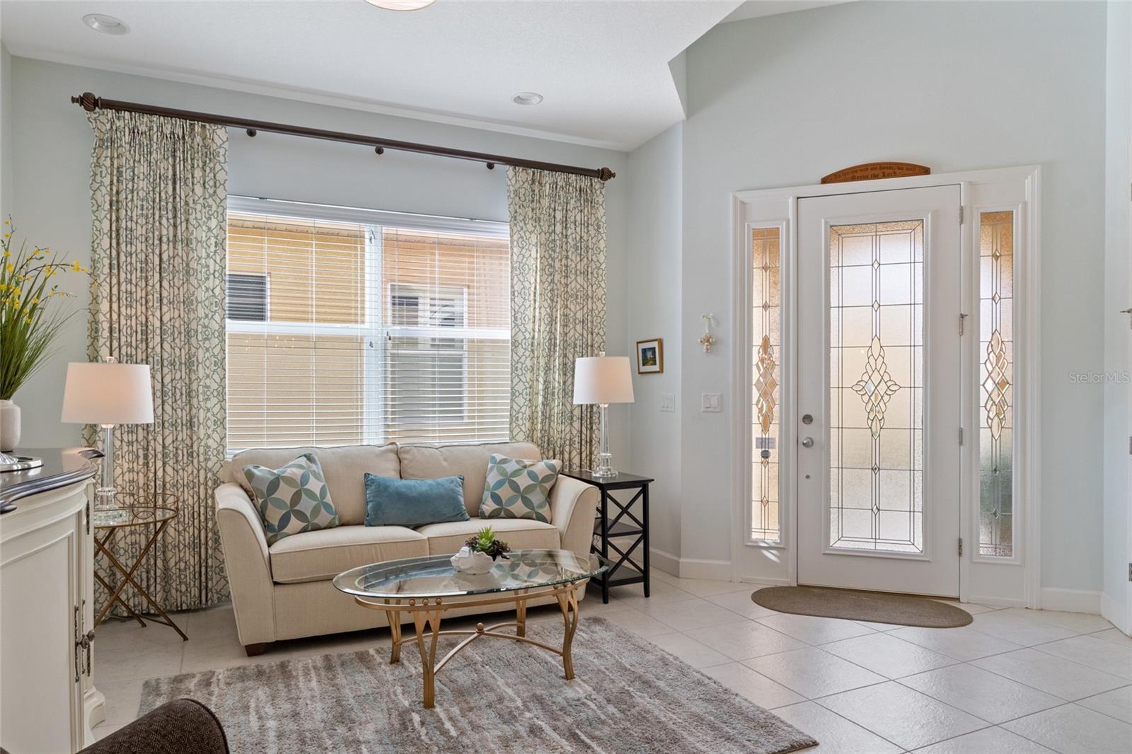 Formal seating area with 10 ft ceilings and recessed lighting as you enter your Florida home