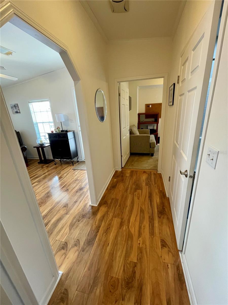 Looking from the middle bedroom, hall bath 1st door on the right, and front bedroom straight ahead. This hall way is found right off the Living Room