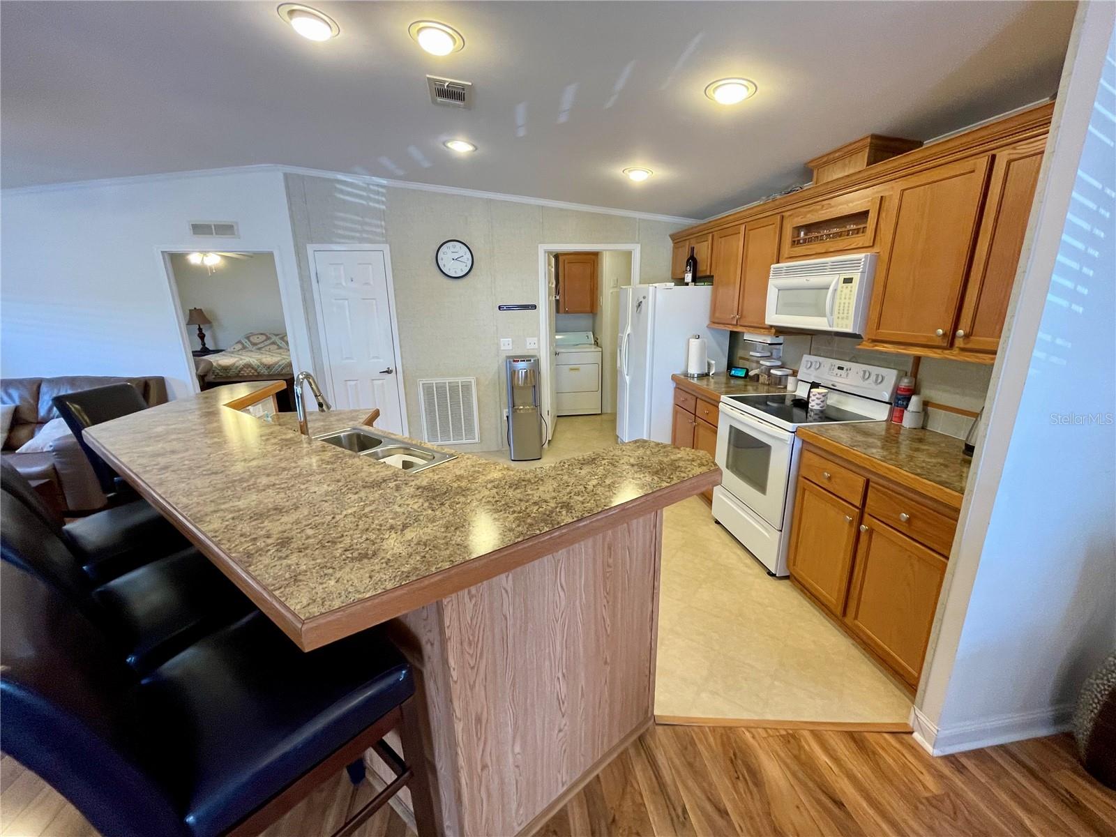 Notice the ceilings, laundry closet to the right, pantry in the middle, and the Primary bedroom is to the left.