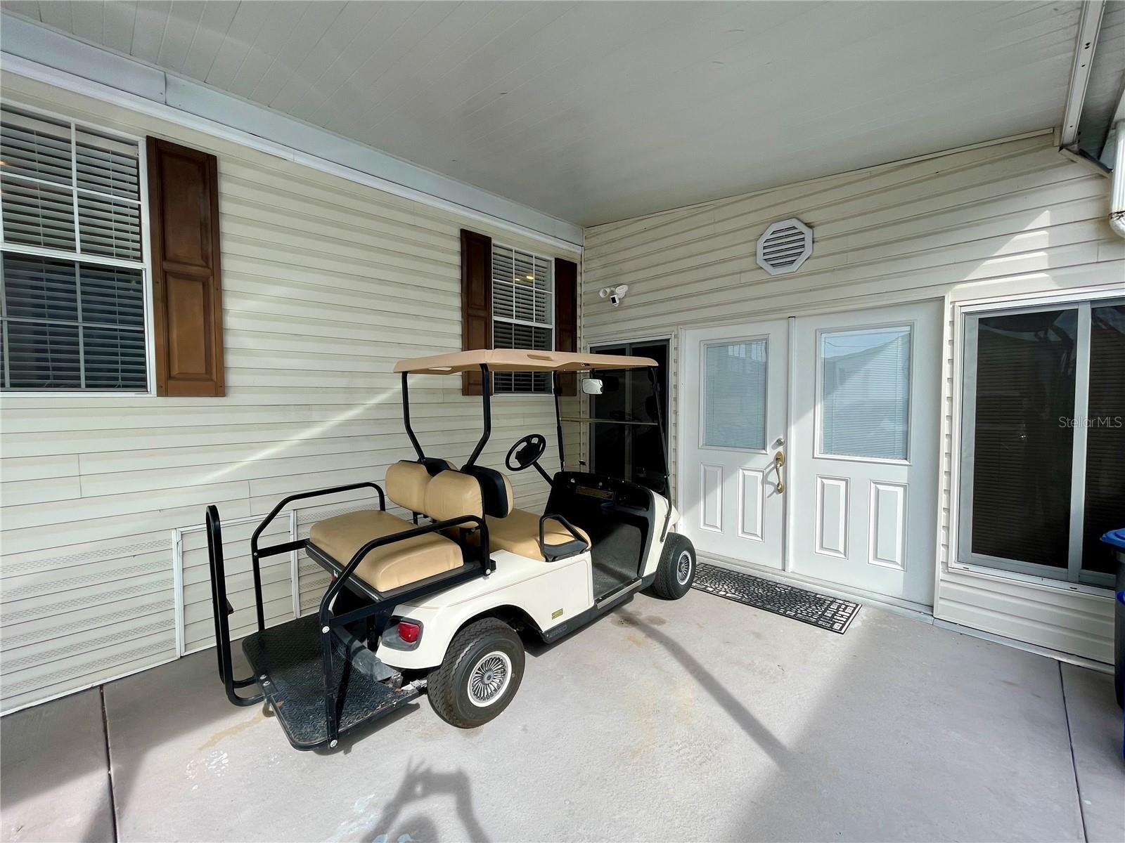 Double doors into the Florida room... Golf cart stays with the home.