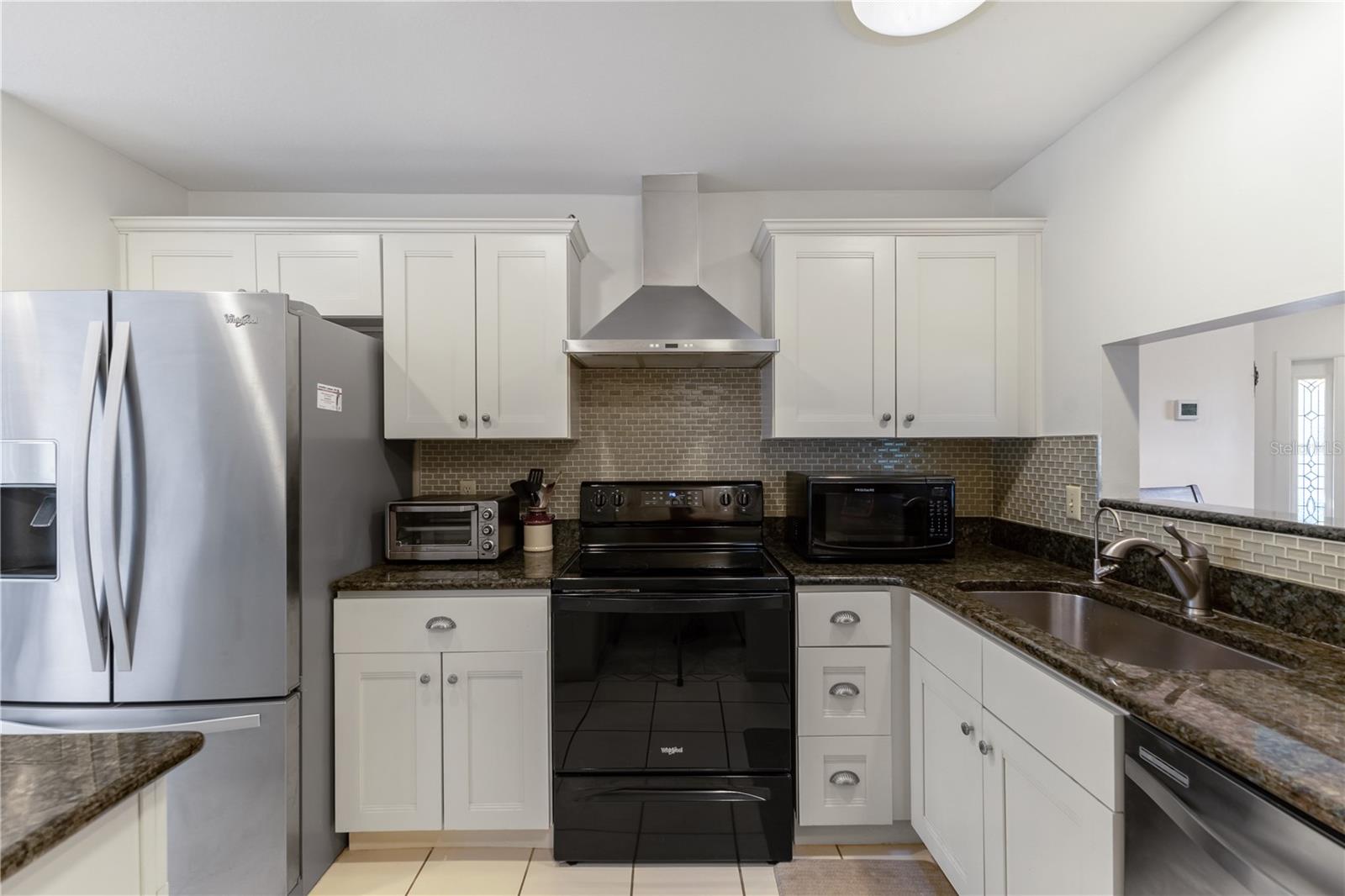 Updated Kitchen with newer appliances, stylish backsplash and cabinet hardware