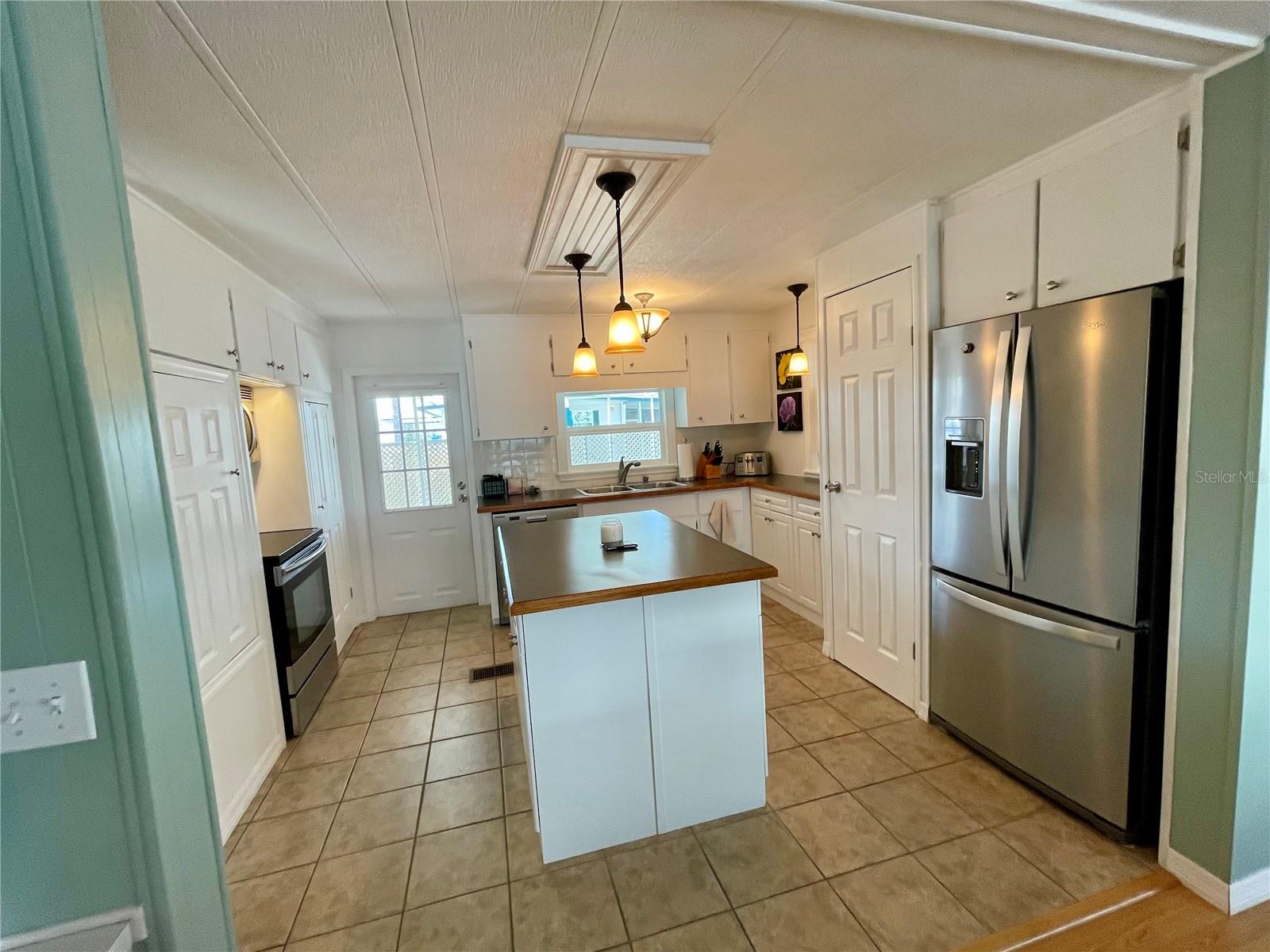 Pantry next to the refrigerator. Door straight ahead leads to the Lanai