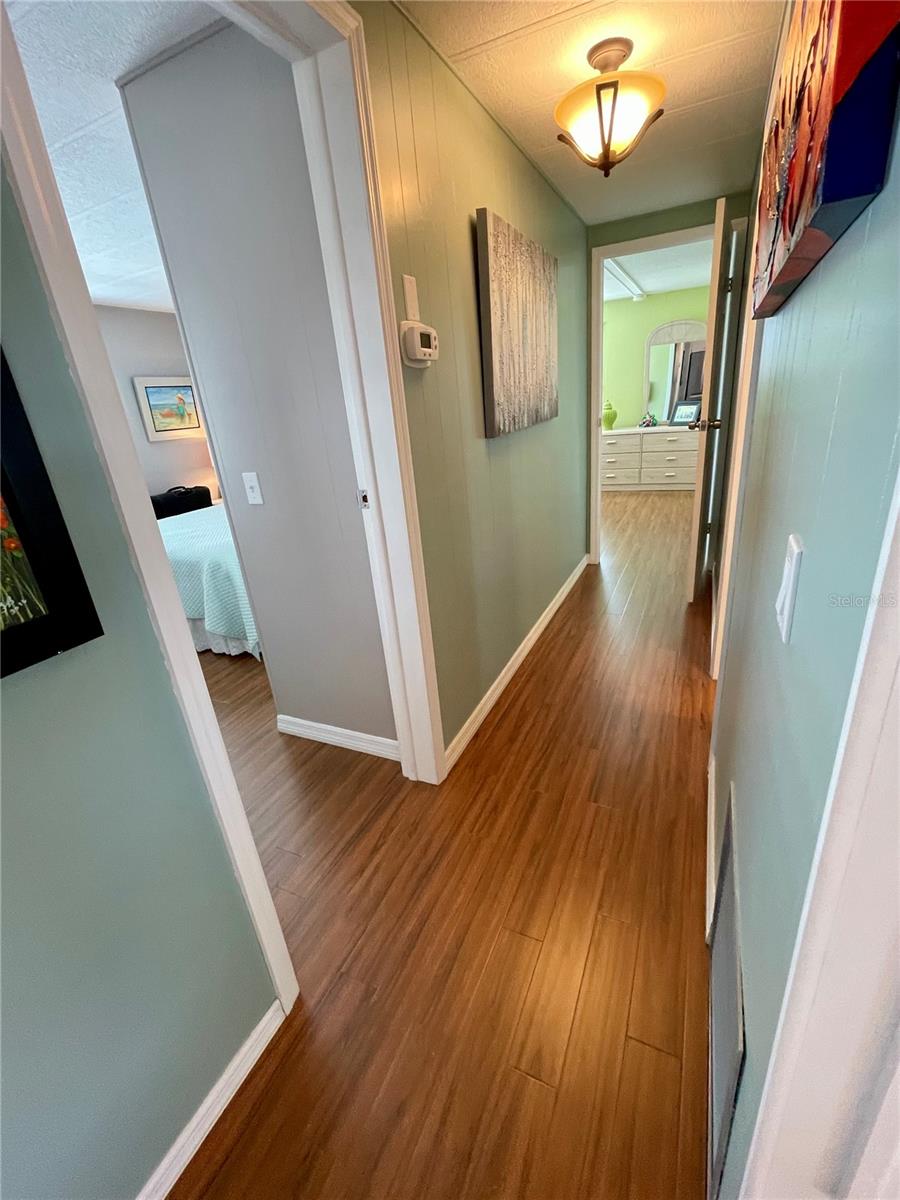 Down the hall, 2nd bedroom to the left, hall bath down on right, and the Primary bedroom and on-suite is at the back of the home