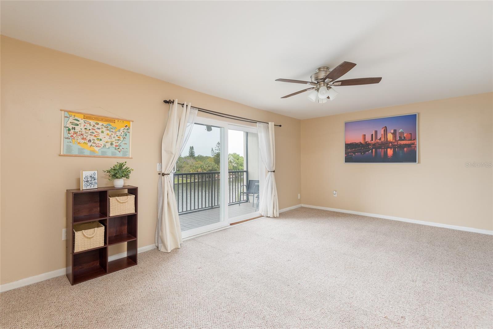 Living room leads to waterfront balcony