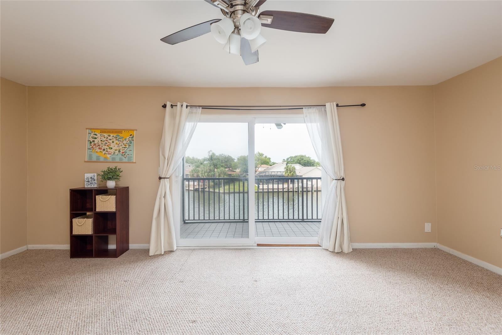 Living room leads to waterfront balcony