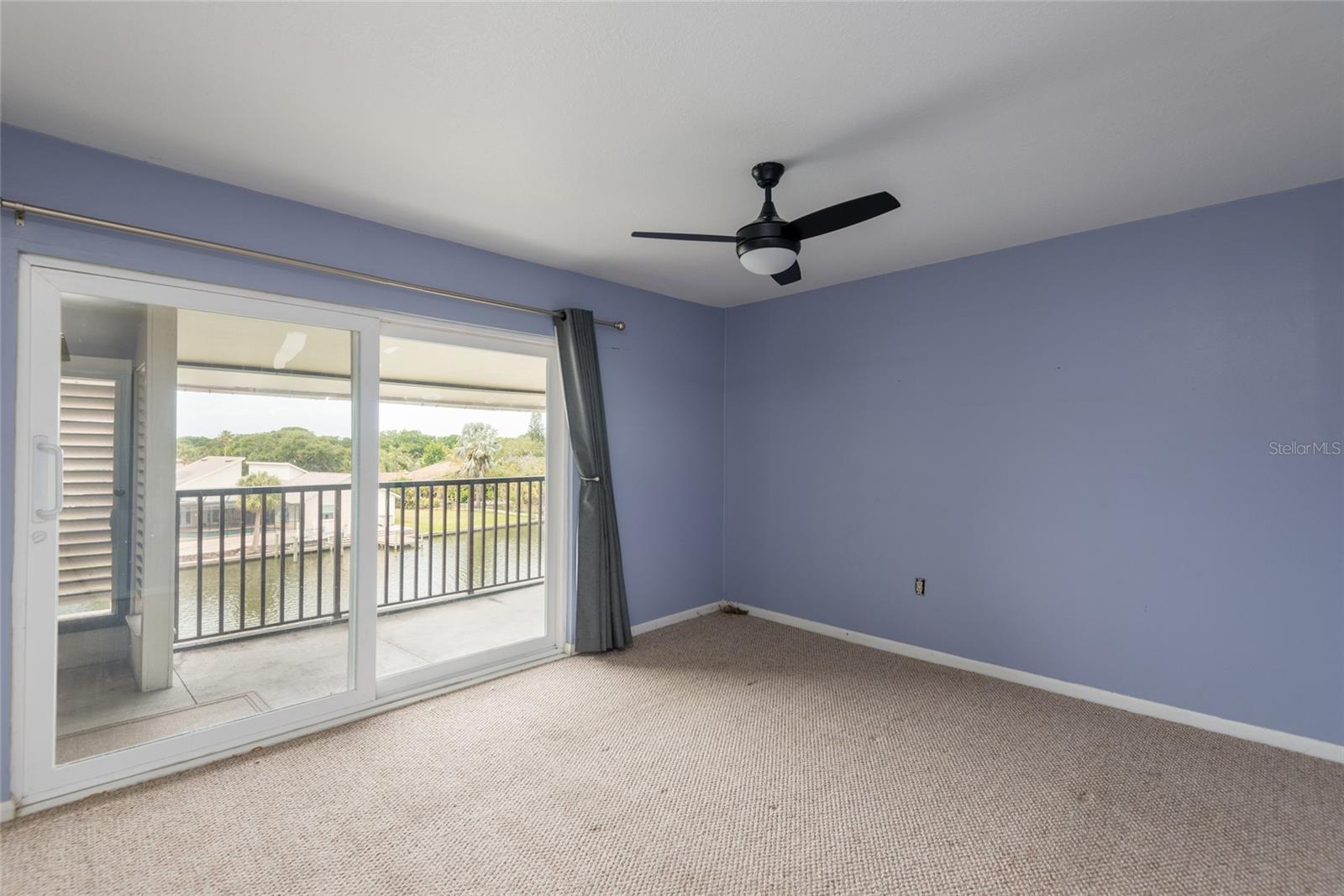 Large primary bedroom is full of natural light