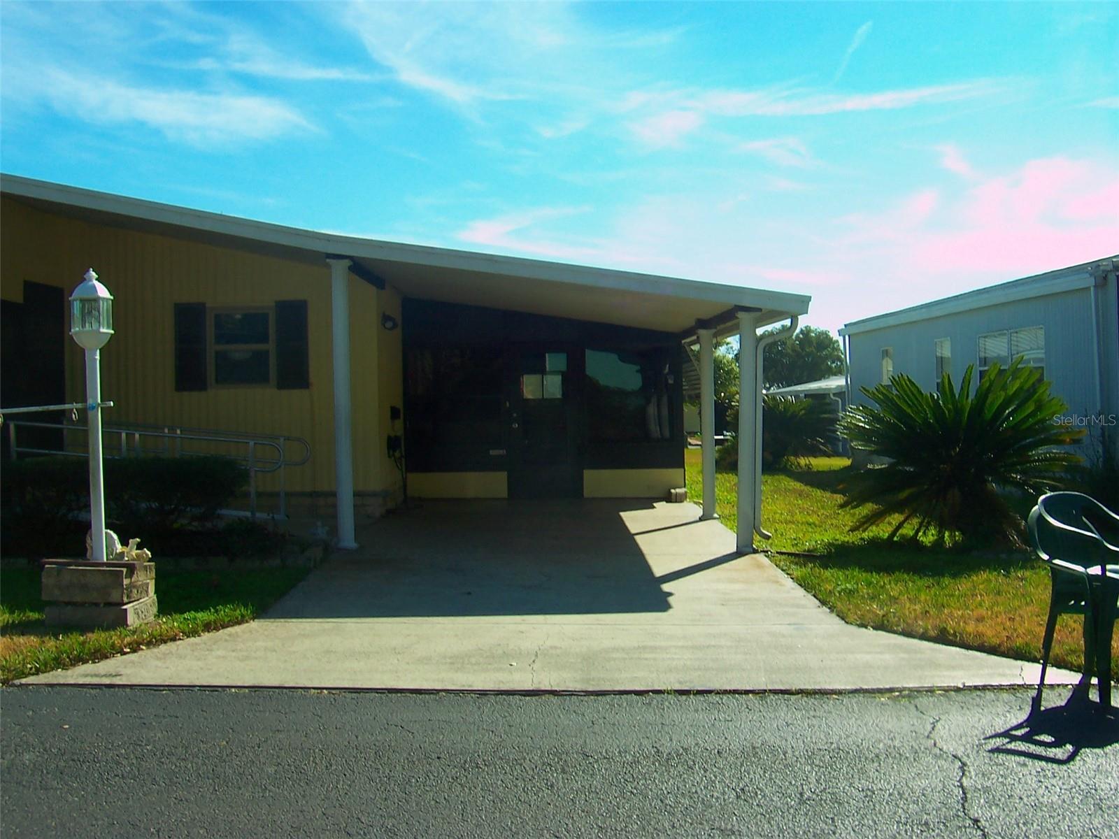 Nice wide Driveway with ornate fluted columns on the side of the carport.