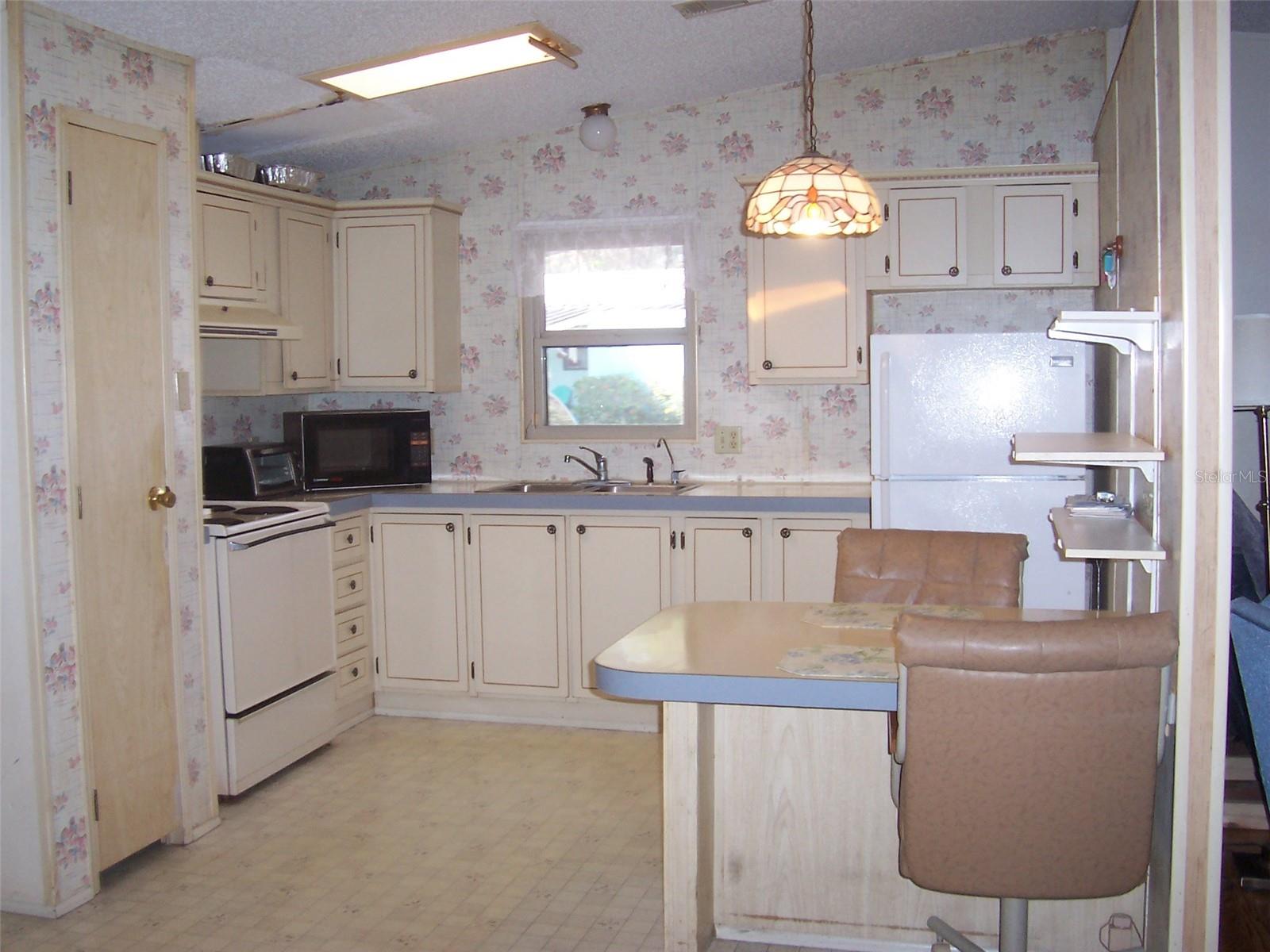 Well designed kitchen with ample cabinets and pantry.