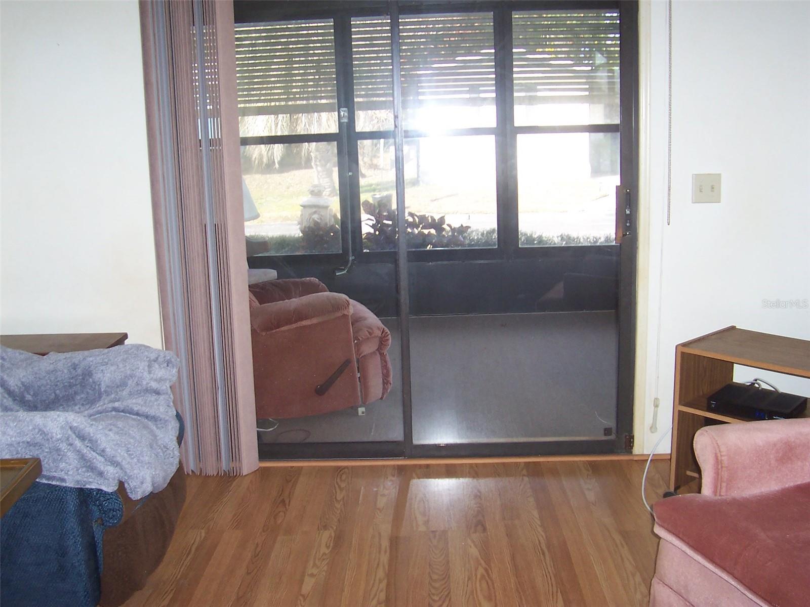 Nice view of front porch and outside through sliding glass doors.