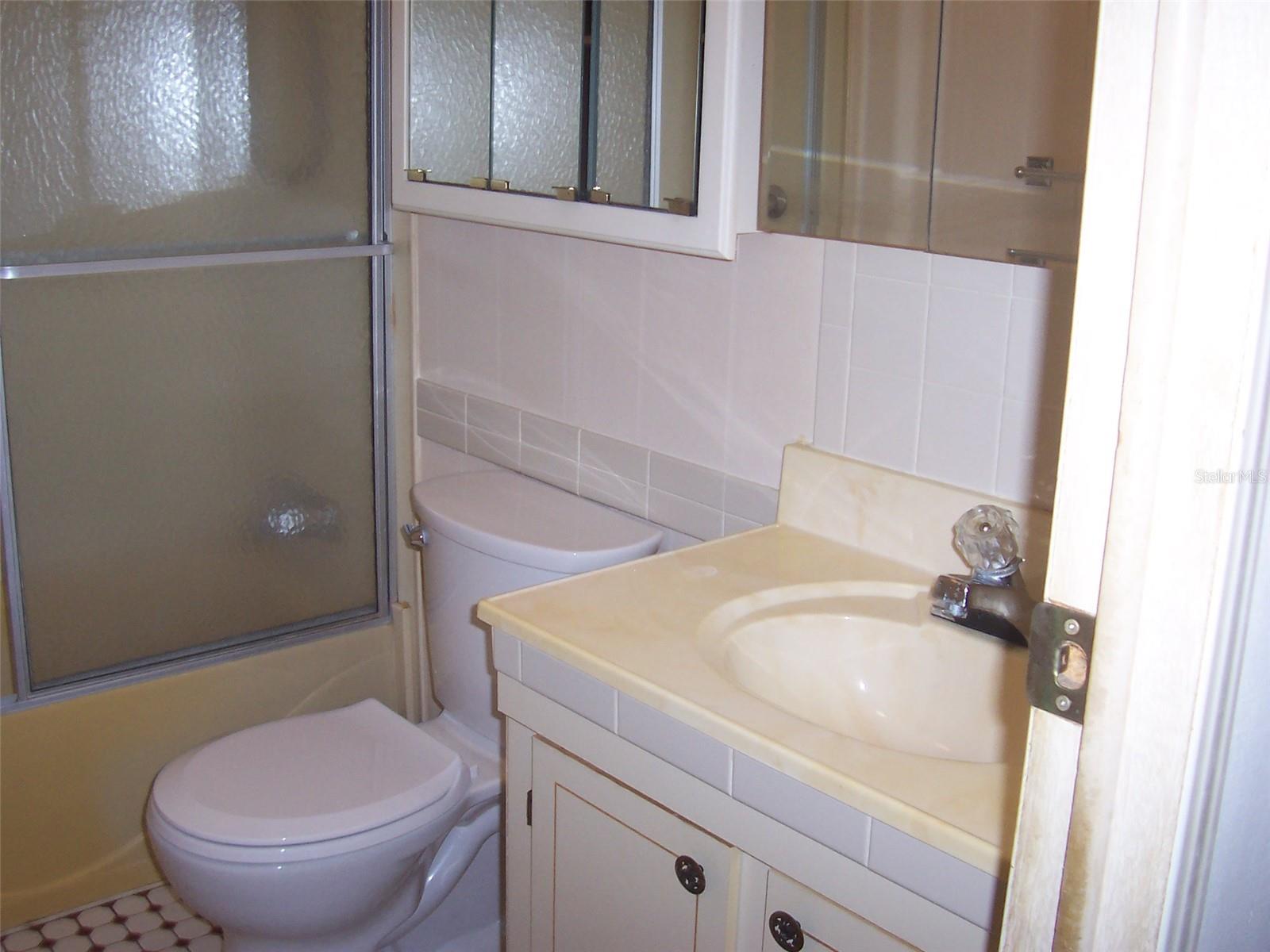 Guest bath with tub/shower combination.