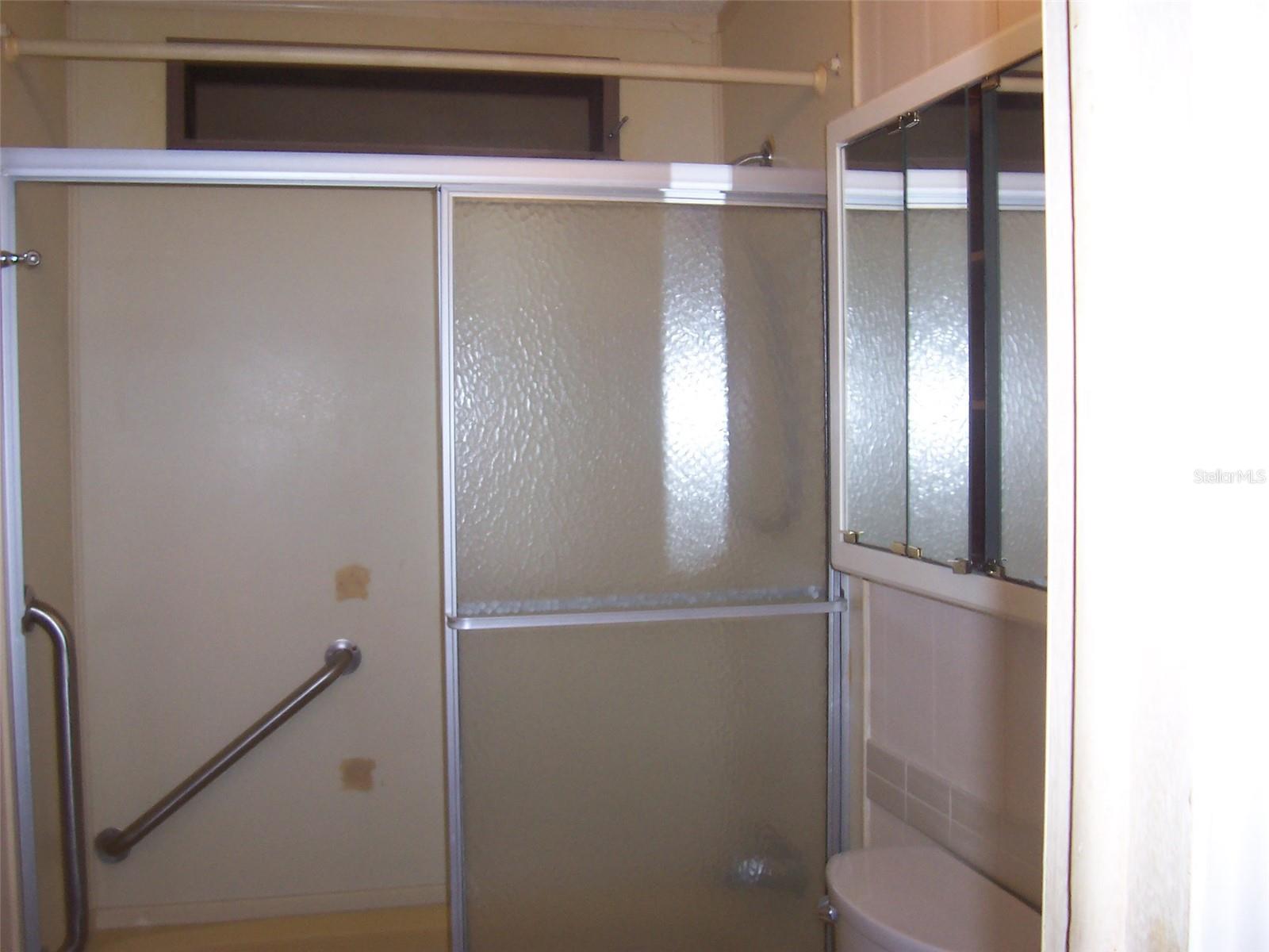 Guest bath also features grab bars in tub/shower area.