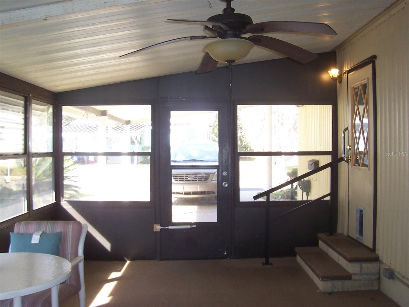 Carport Entry into 17 x 11 glassed in side porch.