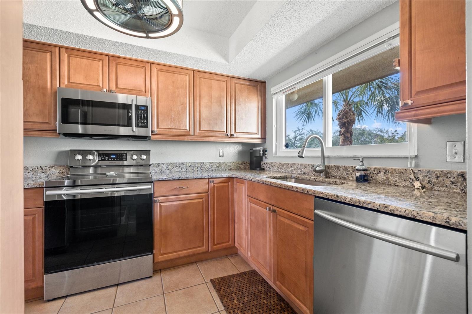 Updated kitchen with stainless steel appliances and granite counters