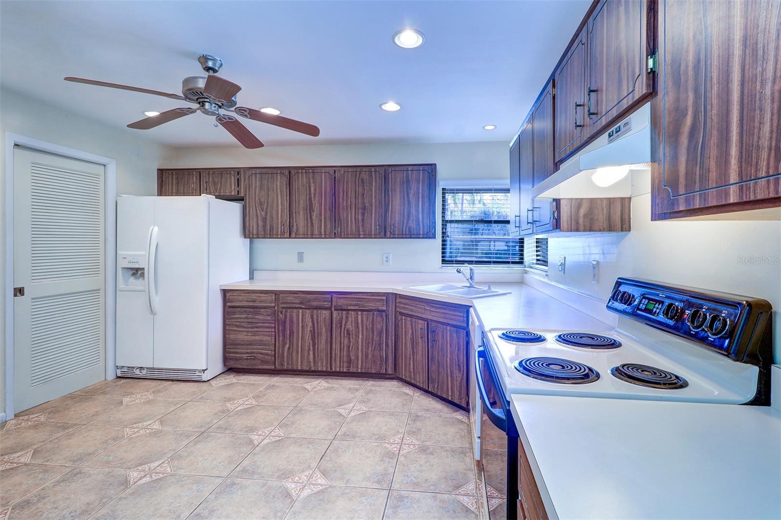 Kitchen with loads of cabinets and countertops