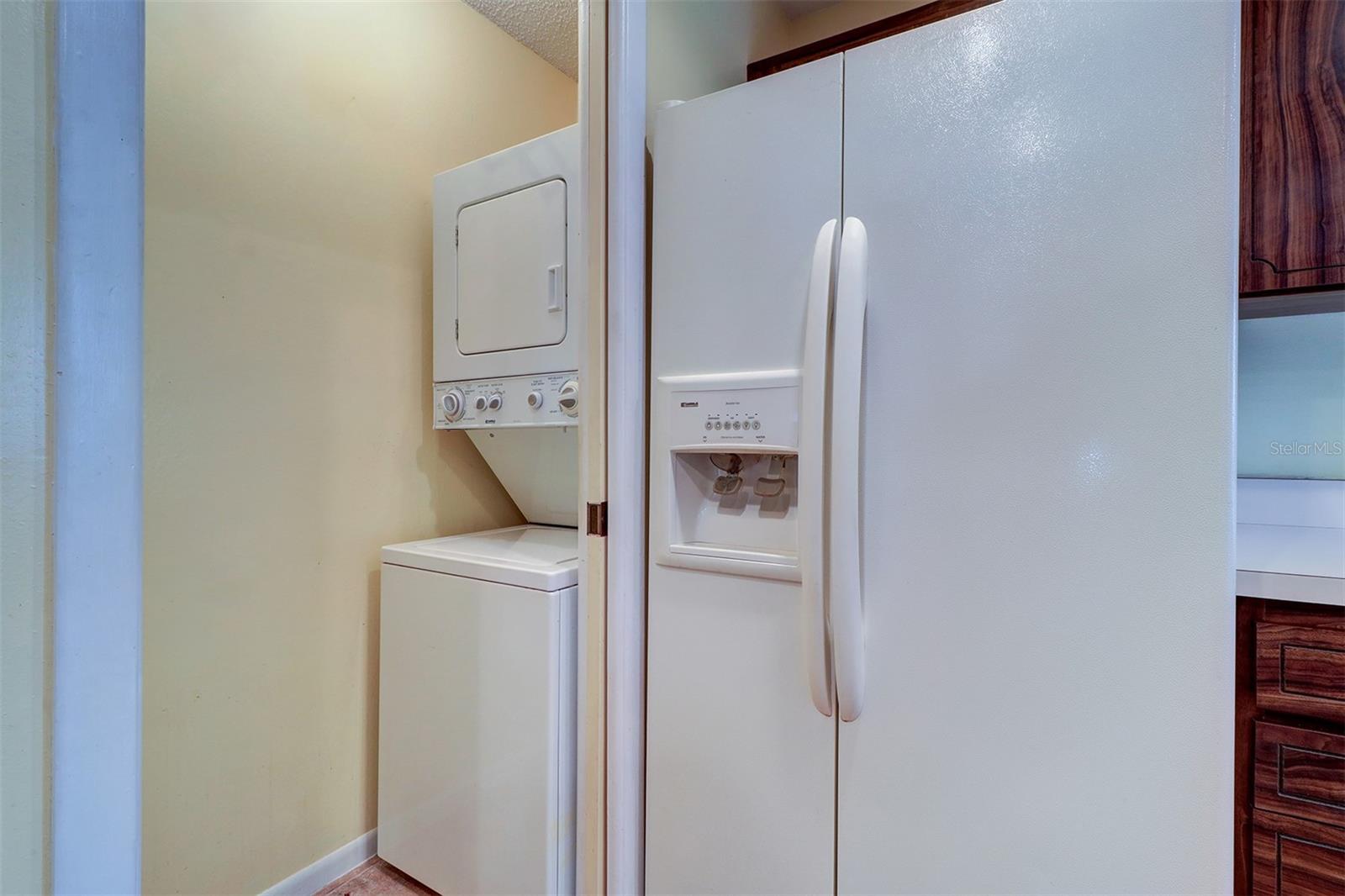 Stackable washer and dryer off kitchen