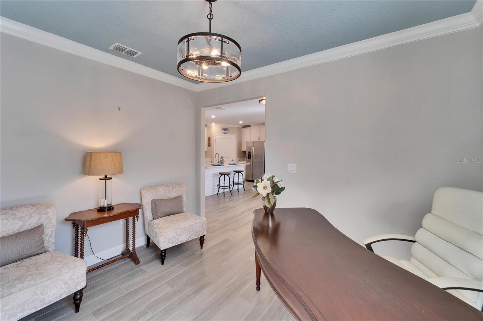 Home office/ den with crown molding and upgraded lighting.