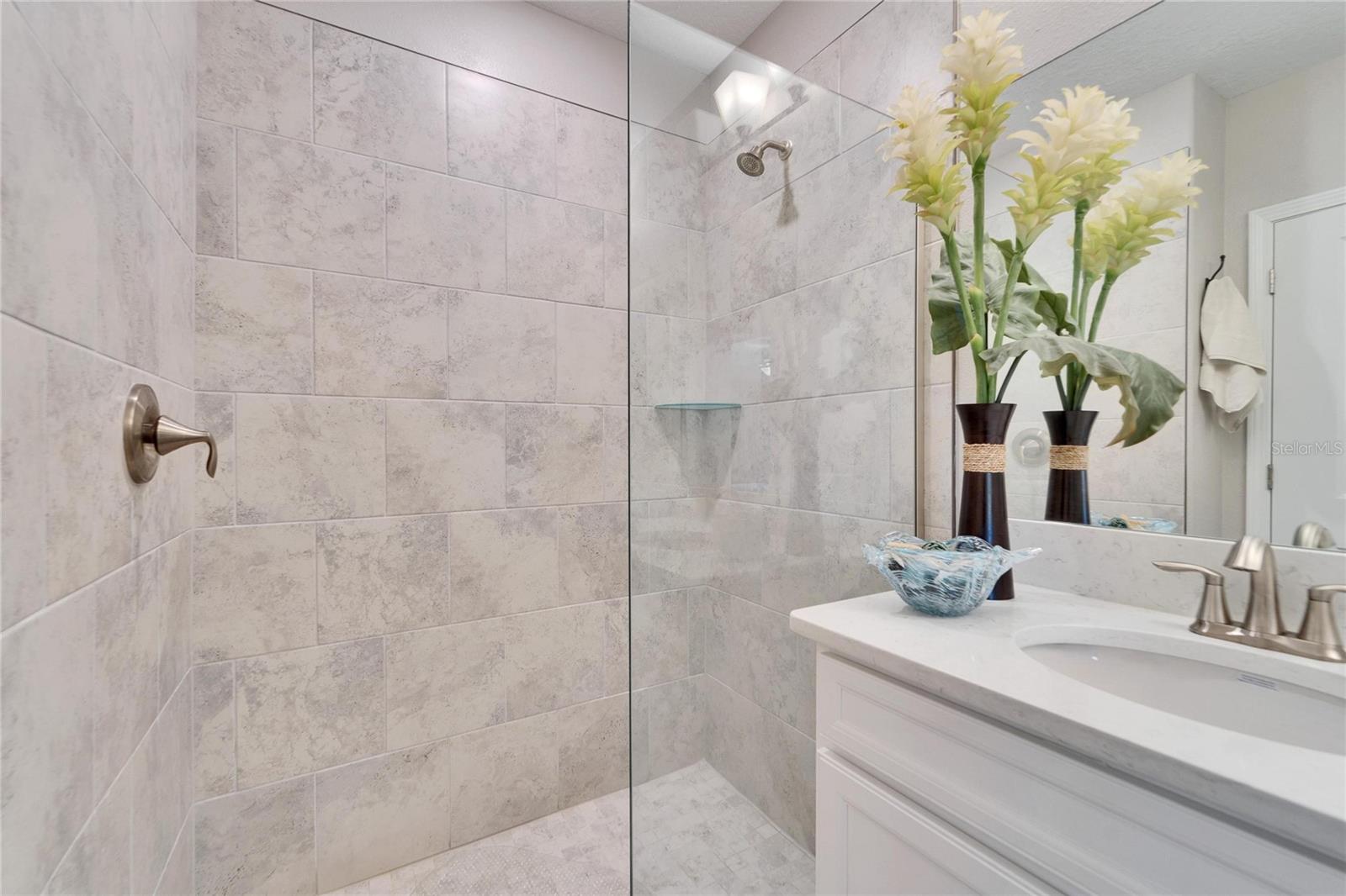 Primary Bathroom with step in shower, and dual sinks.