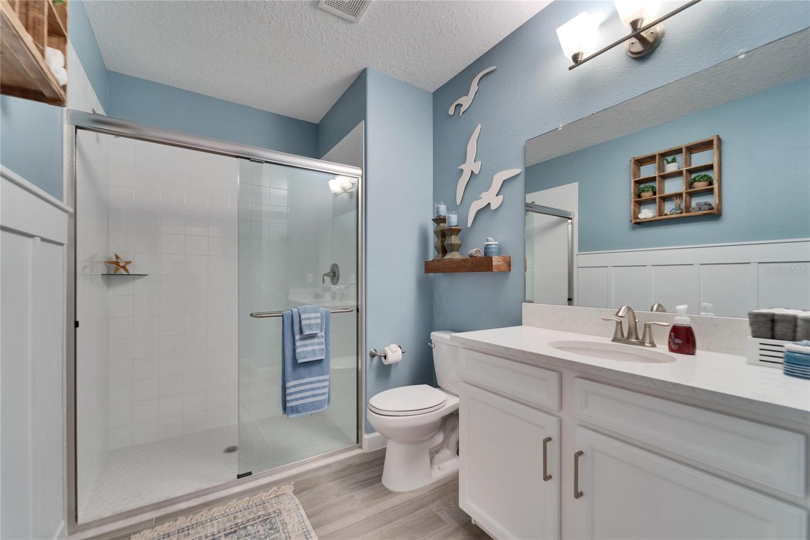 Guest bathroom with step in shower.