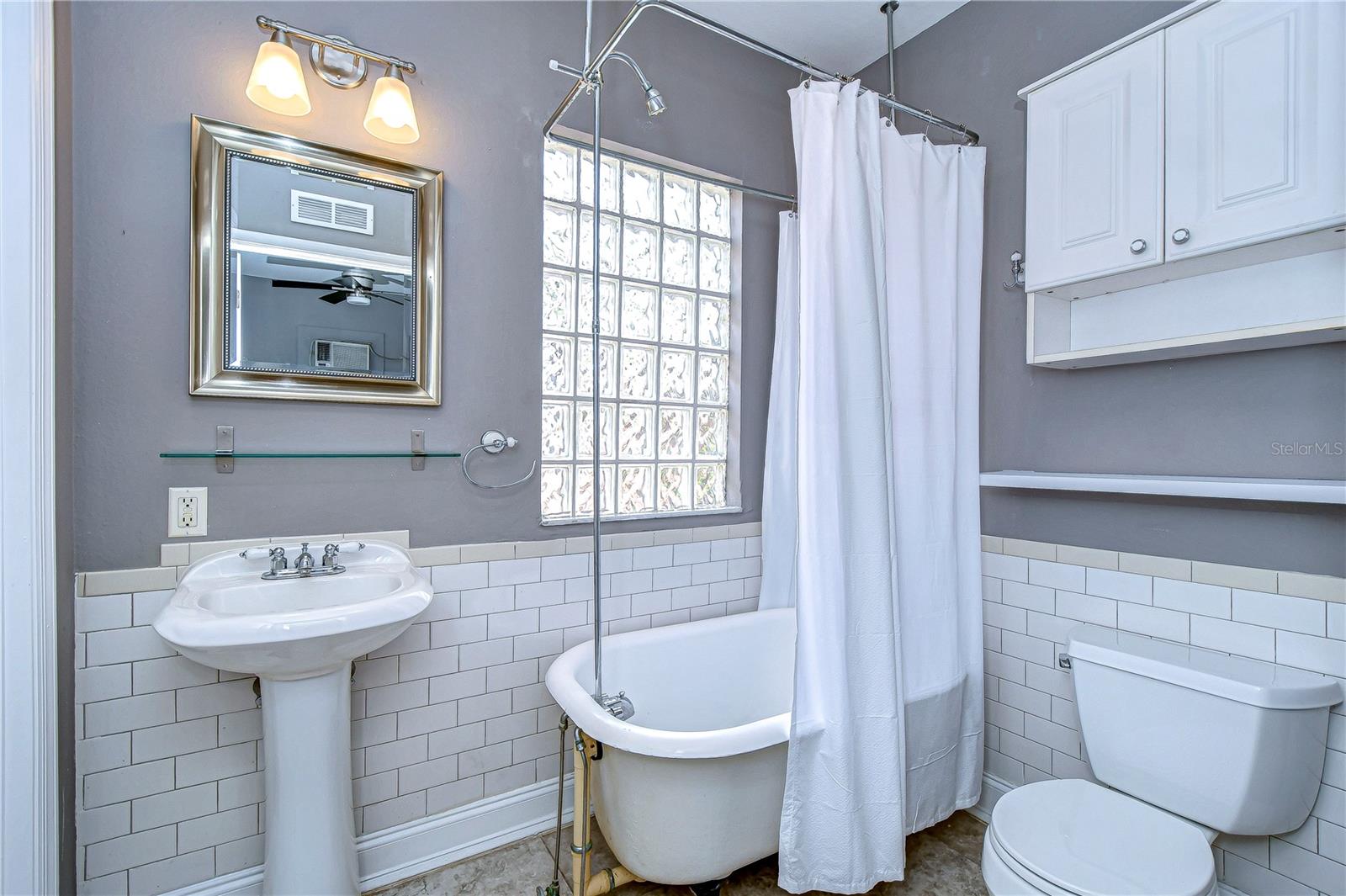 Standing tub and shower combo speak to the historical aspect of the home!