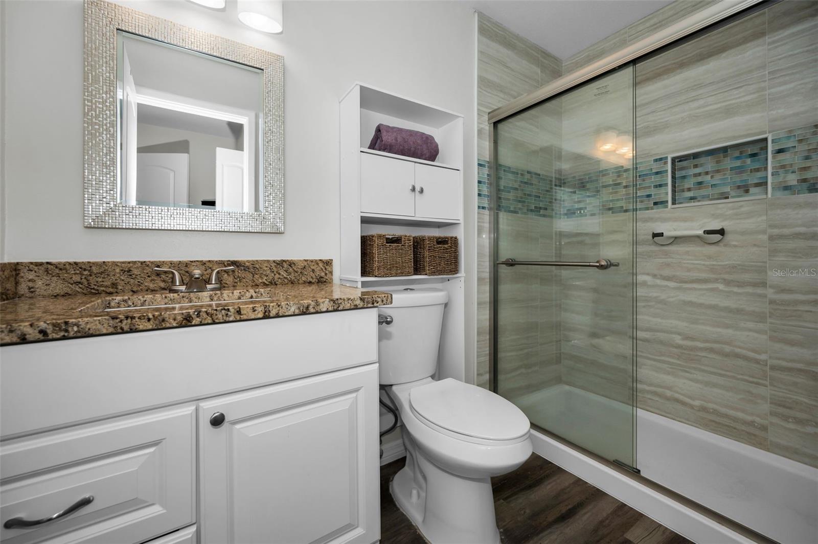 Lovely updated Master Bathroom with granite counters, newer toilet and remodeled Step-In Shower for ease & convenience.