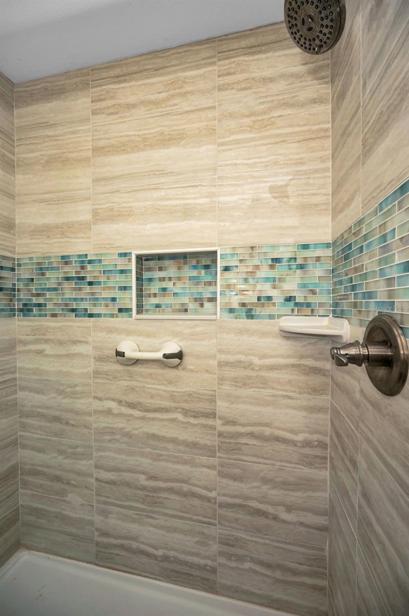 Ease & convenience with this New Master Bath Step-In shower with glass doors.