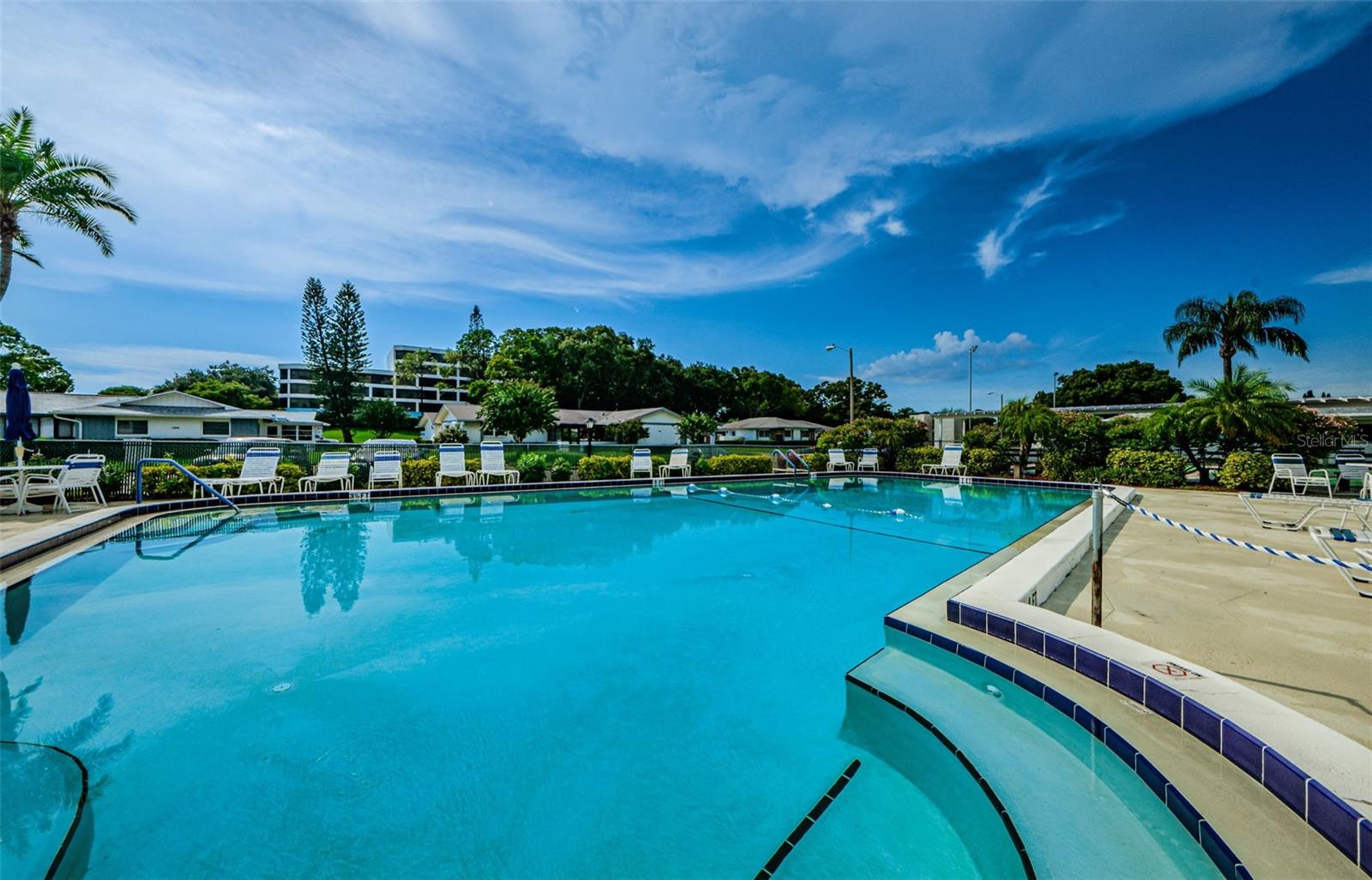 Sparkling Community Pool with poolside lounge chairs