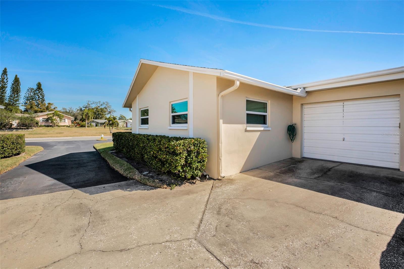 Driveway on side of home leads to the rear attached Garage entry.