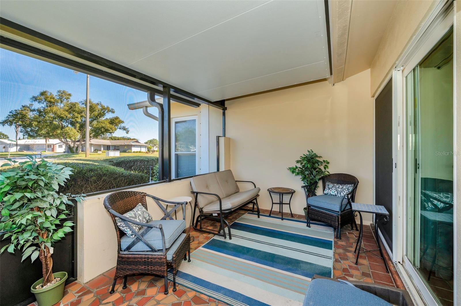 Screened Lanai provides year-round enjoyment. Owner states there is a center support beam built-in which would support a ceiling fan or light.