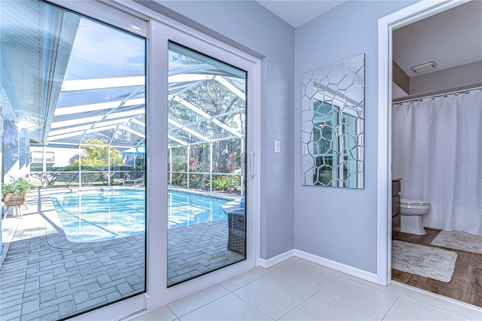 Glass sliders leading out to the pool light the home up with sunlight!