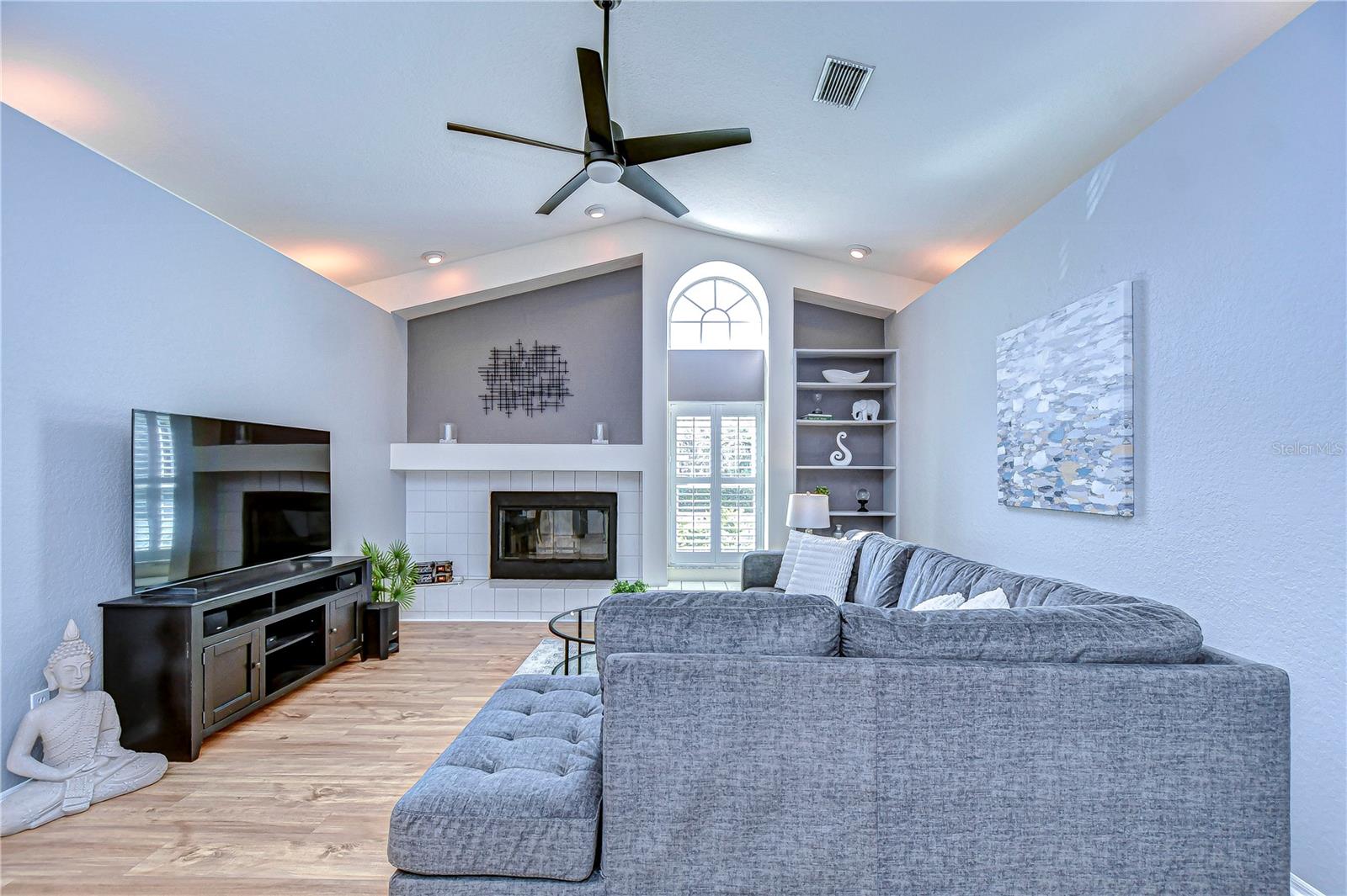 Living room is beautifully appointed with built ins and a fire place!