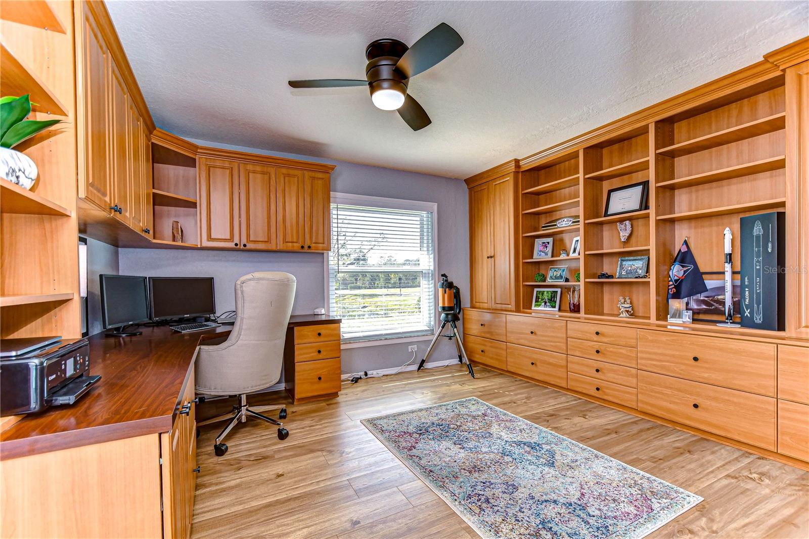 Expansive office with custom built ins. makes for the PERFECT home office!